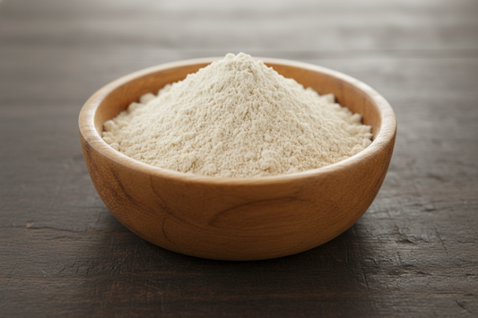 red maca root powder that's very light beige in color placed in a wooden bowl. nothing else on the table. No labels