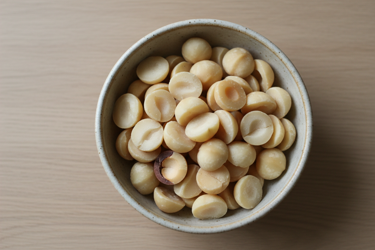 split macadamia nuts with no shells in a bowl